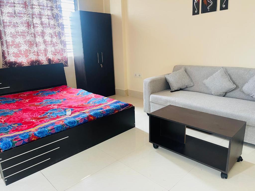 a living room with a bed and a couch at The Lakeview Apart-Hotel in Agartala