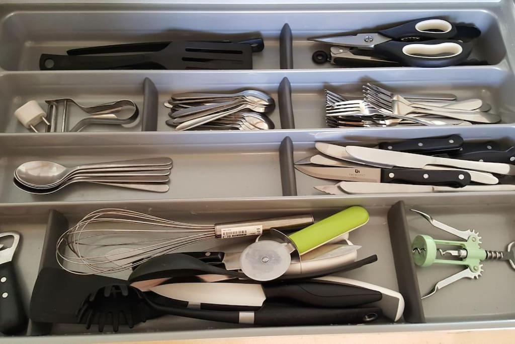 a drawer full of kitchen utensils in a drawer at La Parenthèse Clissonnaise plein centre historique in Clisson