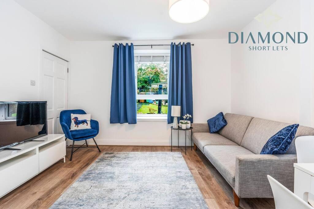 a living room with a couch and a window at FOUNDRY - 2 Bedrooms, Fully Equipped, Free Parking, WiFi, FAVOURITE for Contractors, Long Stays Welcome, Food, Bars, Shops by Diamond Short Lets in Dunfermline