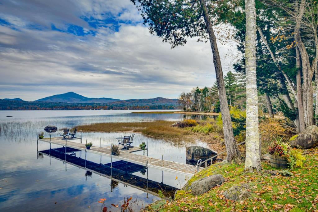 a dock on a lake with mountains in the background at Waterfront Lake Webb Cabin Rental with Dock and Views! 