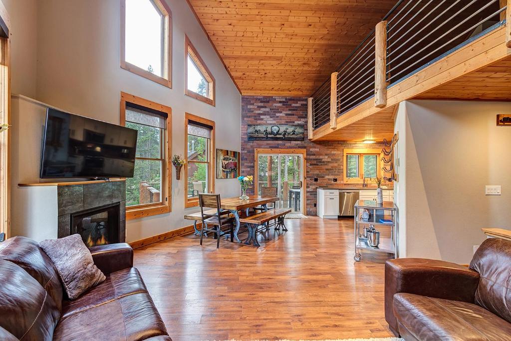 a large living room with a couch and a fireplace at Gorgeous updated mountain home just minutes from the slopes, private hot tub, pool table! in Breckenridge