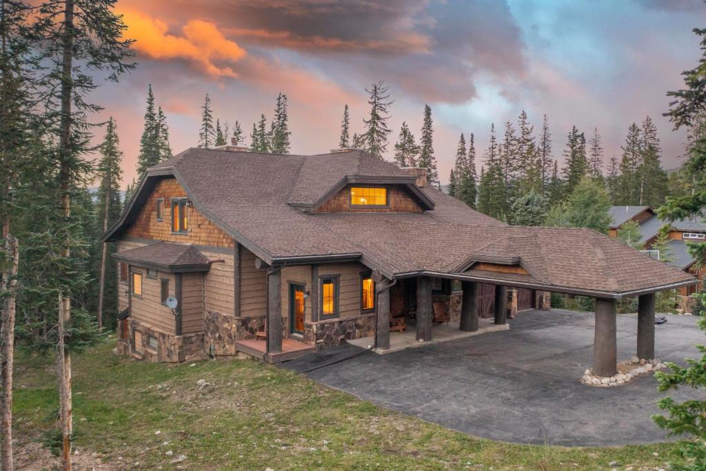 a house in the woods with a roof at Expansive elegance at base of Peak 8, 6 en-suites, 9 fireplaces, game tables, hot tub! in Breckenridge