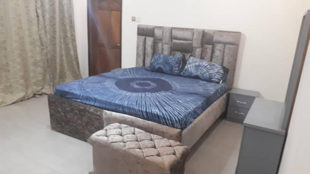 a bedroom with a bed with a blue comforter at Sohna's Paradise Residence 