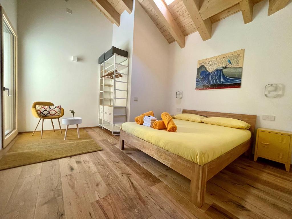 a bedroom with a bed and a chair in it at I Ciliegi del Conte in Bormio