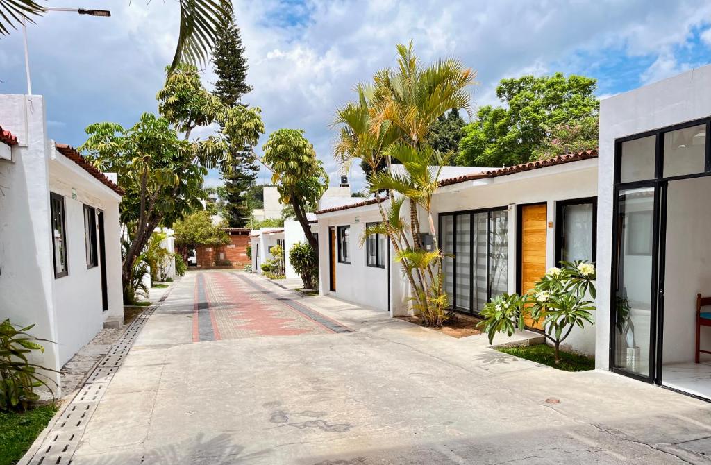 an empty street in a town with white houses at Villa Santa Julia in Oaxaca City