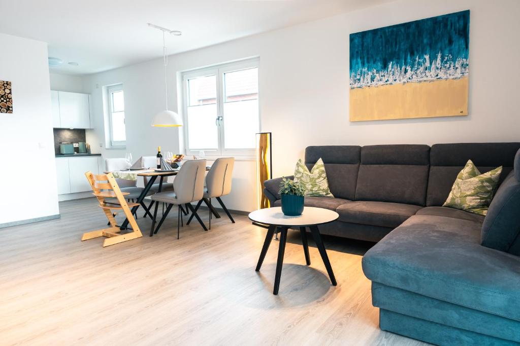 a living room with a couch and a table at Luxuswohnung am Steinhuder Meer - Tierfreundlich - A in Wunstorf