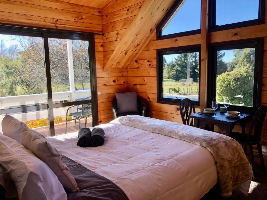 a bedroom with a large bed in a log cabin at The Mountain Stable Studio 