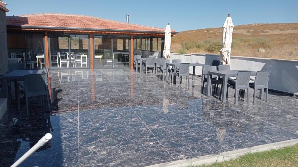 een groep tafels en stoelen op een patio bij Akarca Butik Otel in Tepecik