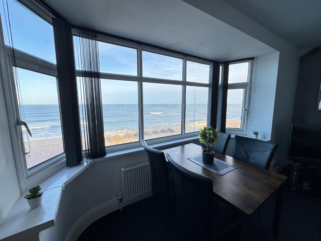 a room with a table with a view of the ocean at Seaviews Apartment 2, Whitley Bay Sea Front in Whitley Bay