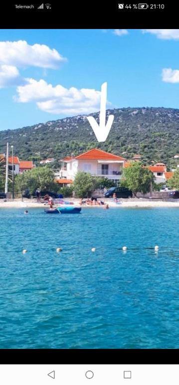 a white bird flying over a body of water at Apartment Natasa in Vinišće