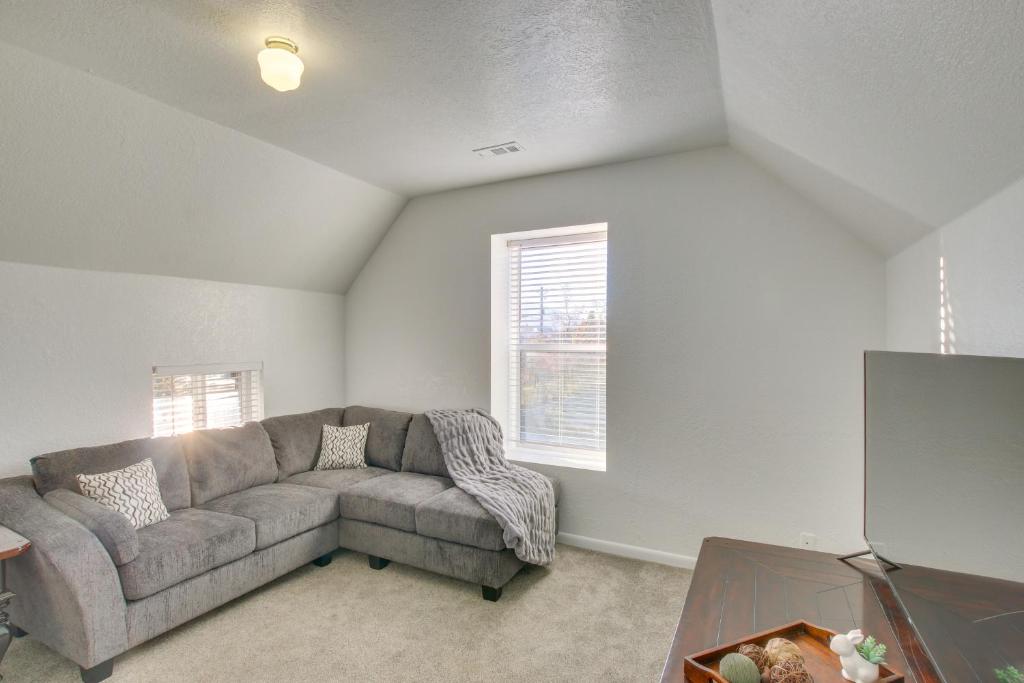 a living room with a couch and a window at Convenient Logan Apartment - 1 Block to Town! in Logan