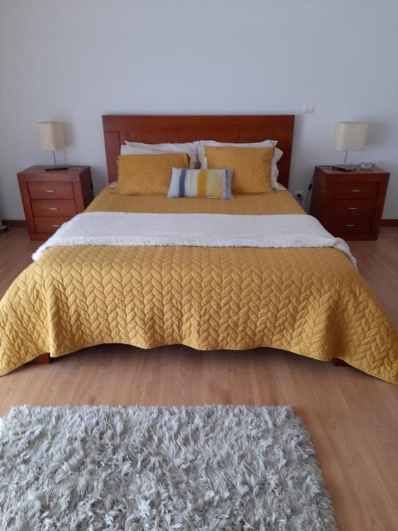 1 dormitorio con 1 cama grande y 2 mesitas de noche en Azoresaccommodation, en Lagoa