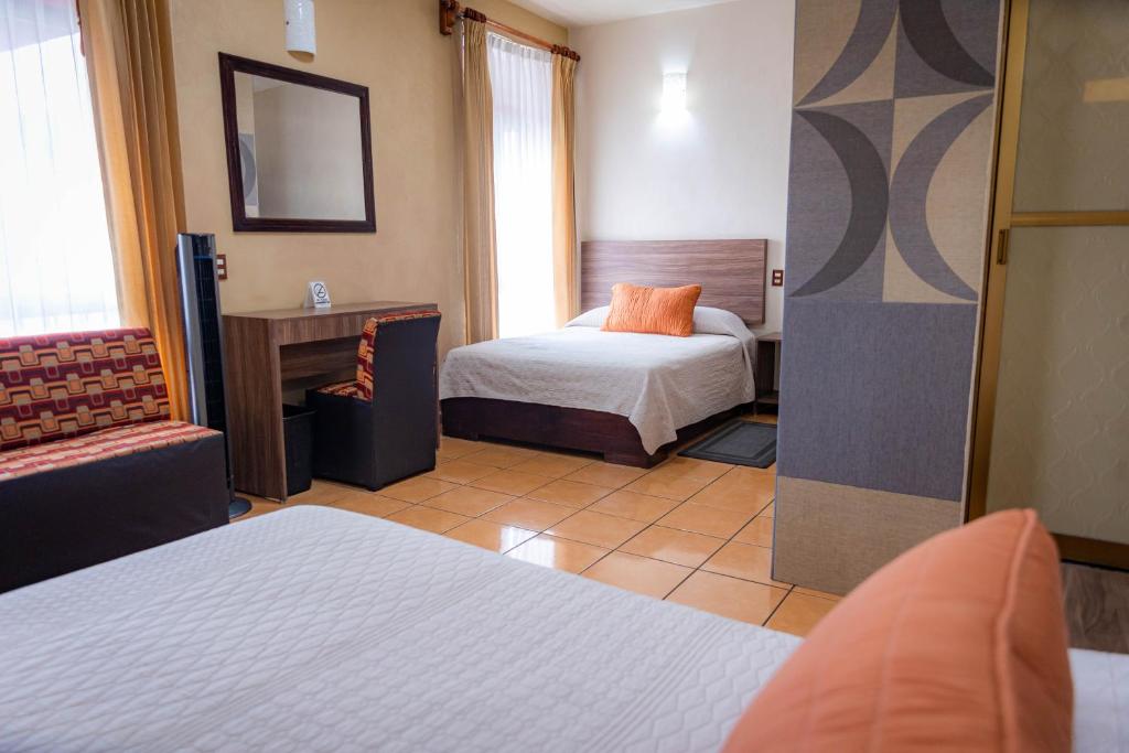 Postel nebo postele na pokoji v ubytování Hotel Estefania