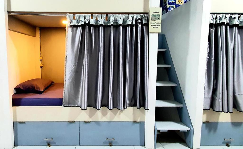 a bunk bed in a room with a window at Tiny Room Hostel in Nusa Penida