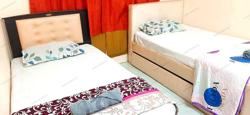 a room with two twin beds and a mattress at AABM HOMESTAY Ipoh in Ipoh