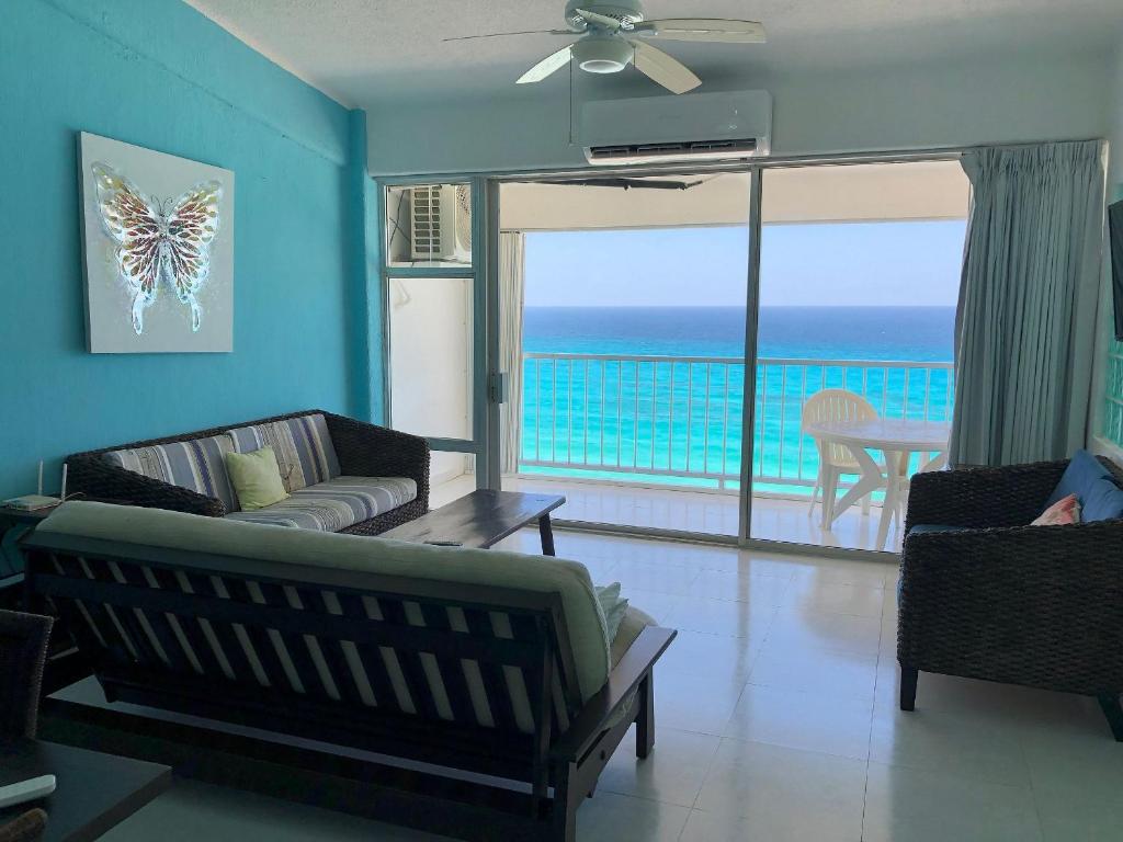 a living room with a view of the ocean at Beautiful Beach Front Pent House in Cancun!!! in Cancún