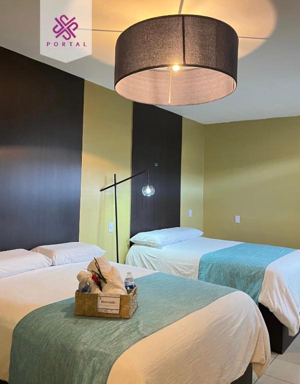 Postel nebo postele na pokoji v ubytování Hotel Portal & Suites
