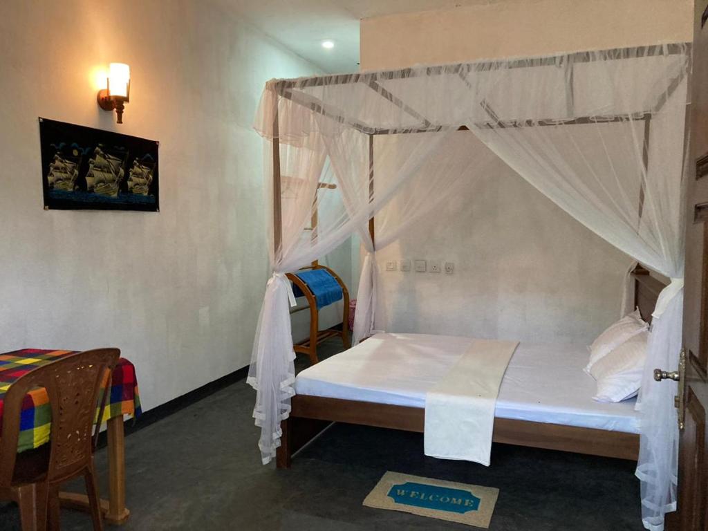 Postel nebo postele na pokoji v ubytování Sayura Beach Hotel