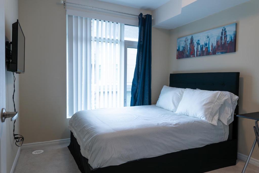 a bedroom with a bed with a large window at The Tranquil Retreat in Toronto