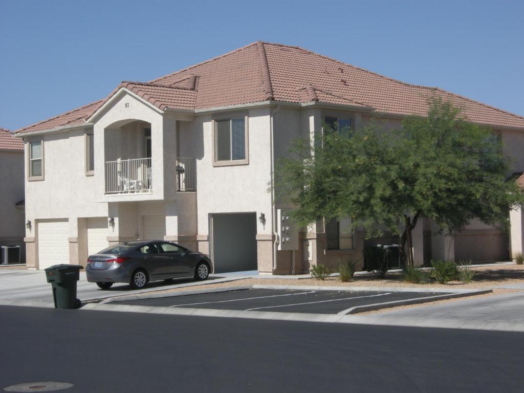 a house with a car parked in a parking lot at Nevada Mesquite Vacation Rentals in Mesquite