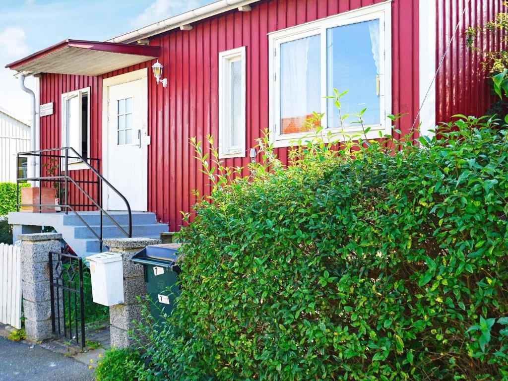a red house with a staircase and a window at Holiday home ENSKEDE in Stockholm