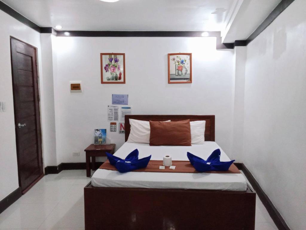 a bedroom with a bed with blue butterflies on it at JACE'S Travelers Inn in El Nido