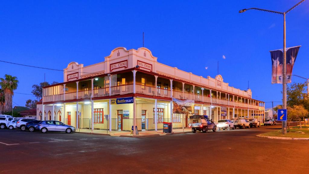 a large building with cars parked in front of it at Hotel Corones in Charleville