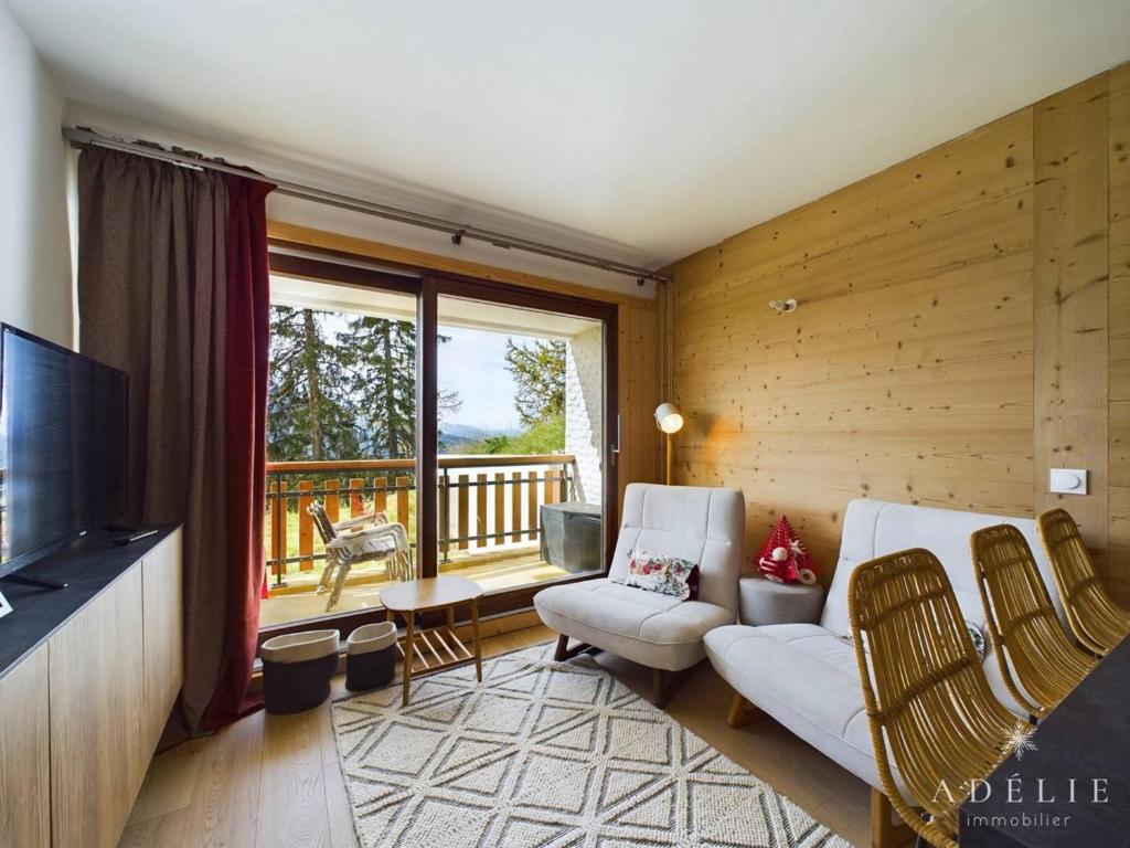 a living room with a couch and a tv and a balcony at Studio Montvalezan-La Rosière, 1 pièce, 4 personnes - FR-1-398-660 in Montvalezan