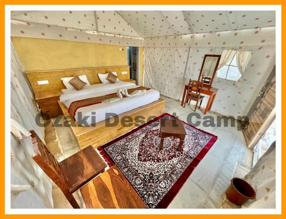 an overhead view of a bedroom with a bed and a table at Ozaki Desert Camp in Jaisalmer