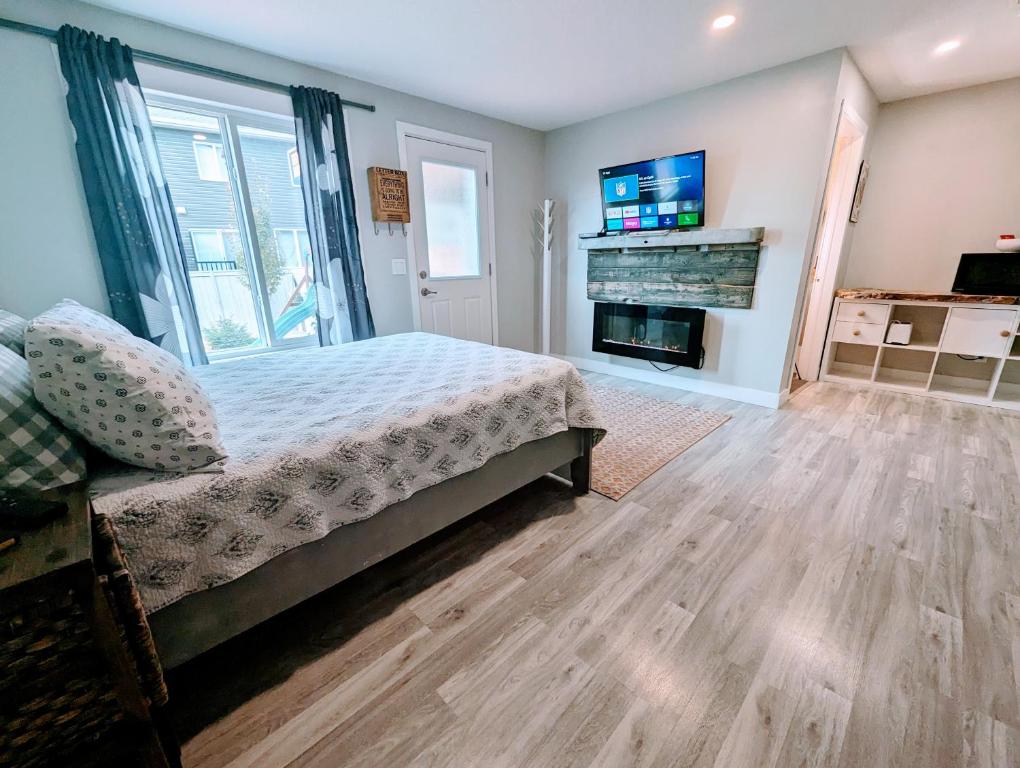 a bedroom with a bed and a fireplace at Hillcrest Hideaway in Airdrie