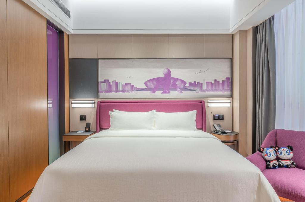 Postel nebo postele na pokoji v ubytování Hampton by Hilton Dongguan Central Plaza