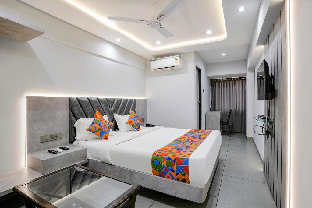 a hotel room with a bed and a tv at FabHotel Aahan in Navi Mumbai