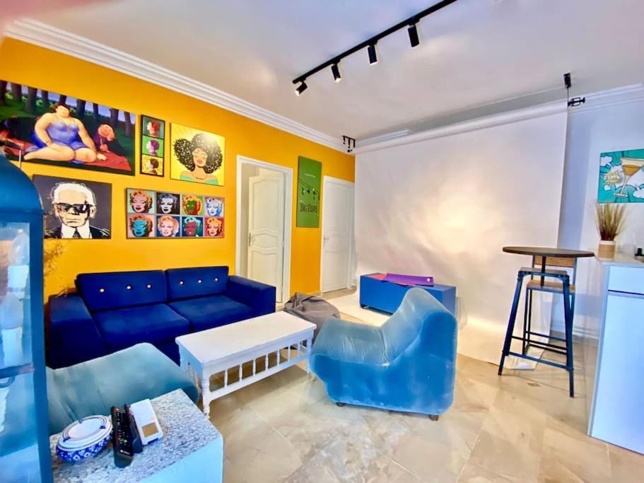 a living room with a blue couch and a table at S+1 au cœur de la Marsa plage in La Marsa