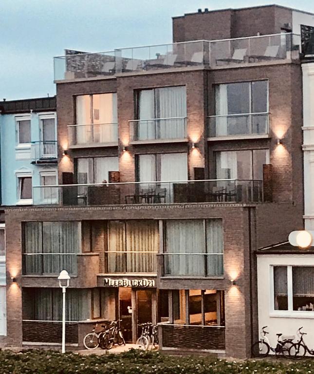a large brick building with bikes parked outside of it at MeerBlickD21 in Norderney