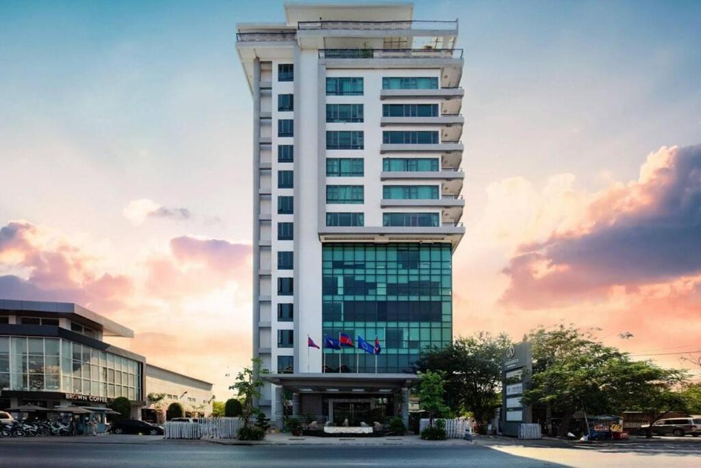 a tall white building with a lot of windows at ANINA Office & Serviced Apartments in Phnom Penh