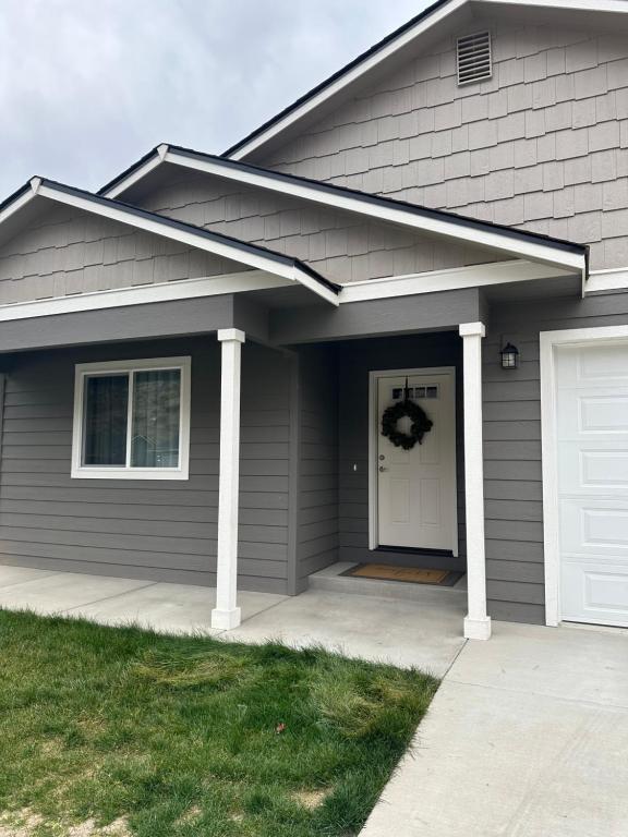 a gray house with a wreath on the door at 5 STAR Rating Home on Rock Island Golf Course 