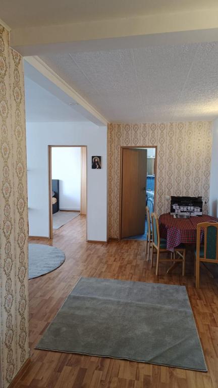 a living room with a table and a dining room at Apartament Marly Cathedral in Gura Humorului