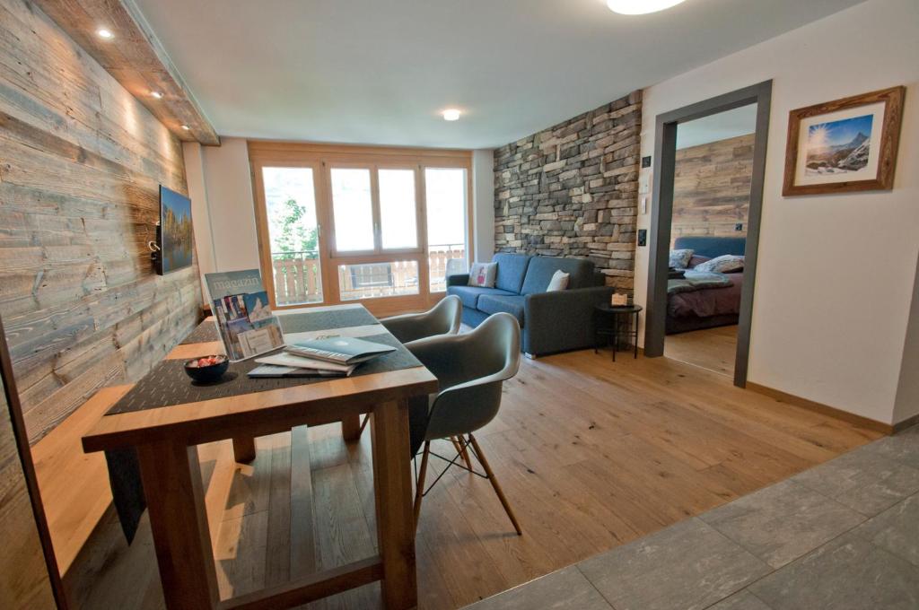 een woonkamer met een houten tafel en een bank bij Z Suite Zermatt in Zermatt
