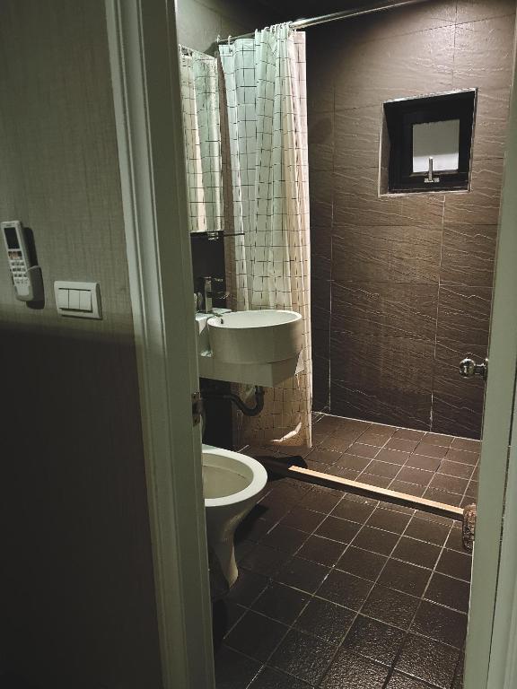 a bathroom with a toilet and a sink at Main Inn Taipei in Taipei