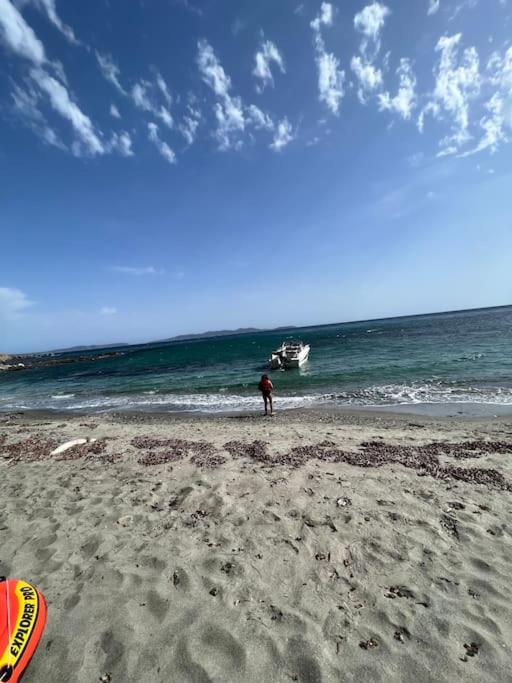 a person standing on a beach with a boat in the ocean at Villa moderne 3 chambres double , proche de la mer, le Micocoulier quartier sainte Marguerite in La Garde