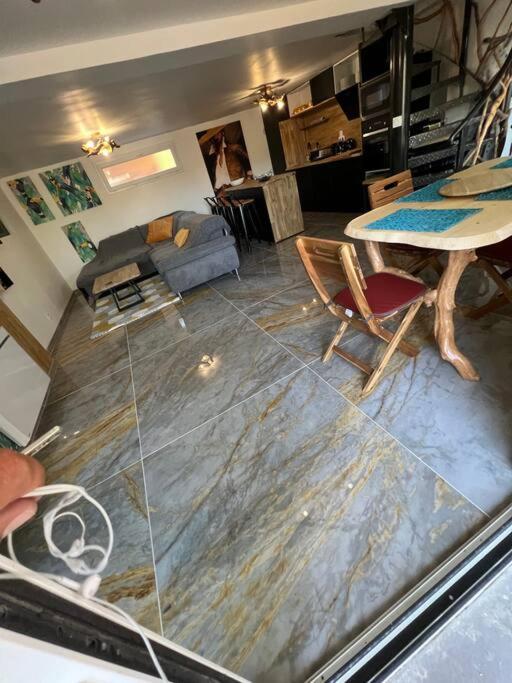 a living room with a table and chairs at Villa moderne 3 chambres double , proche de la mer, le Micocoulier quartier sainte Marguerite in La Garde