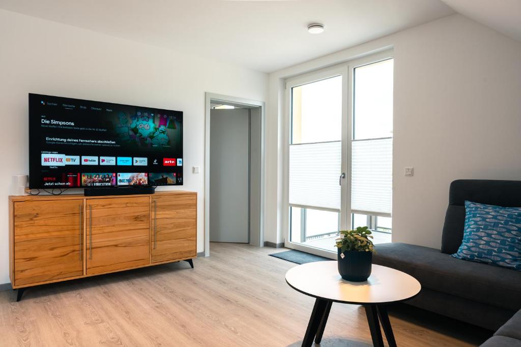 a living room with a large flat screen tv at Luxuswohnung am Steinhuder Meer - Tierfreundlich - C in Wunstorf