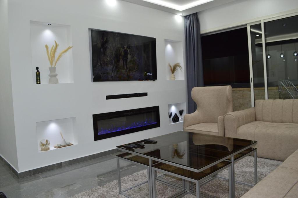 a living room with a fireplace and a couch at Appartement 5 etoiles agadir vue mer in Agadir