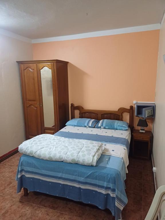 a bedroom with two beds and a tv in it at Fleurvilla in Pereybere