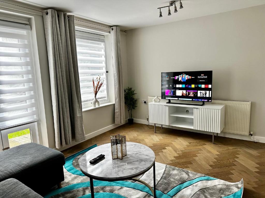 a living room with a couch and a tv at Gero's One Bedroom apartment London NW8 in London