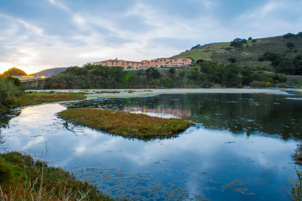 a view of a river with a building on a hill at Hilton Vacation Club San Luis Bay Avila Beach in Avila Beach