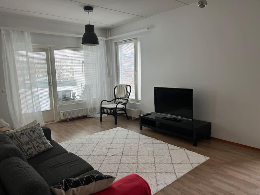 a living room with a couch and a flat screen tv at Apartment Korsholma2 in Vaasa