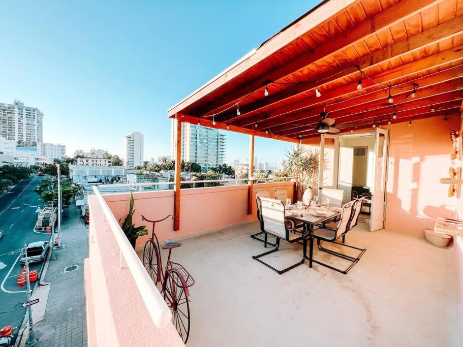 a patio with a table and chairs on a balcony at Picaflor 9 Miramar Comfy Apt PH W/ Amazing View in San Juan