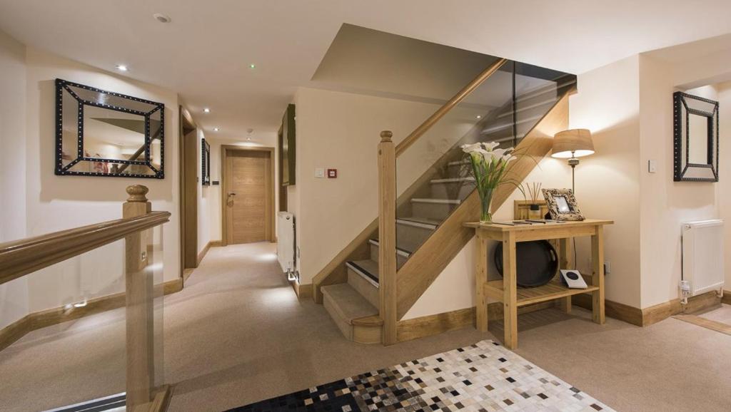 a hallway with a staircase in a house at Hotel du Lac in Villars-sur-Ollon