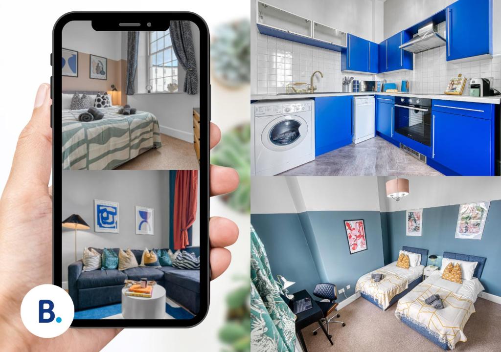 uma mão segurando um telefone tirando uma foto de uma cozinha azul em 2 Bed Stunning Chic Apartment, Central Gloucester, With Parking, Sleeps 6 - By Blue Puffin Stays em Gloucester